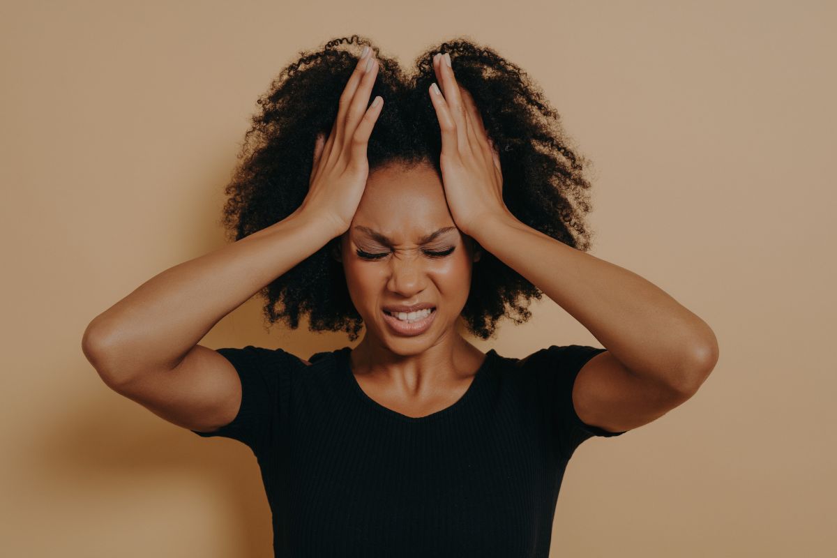 Frustrated moms: Mom holding head in her hands