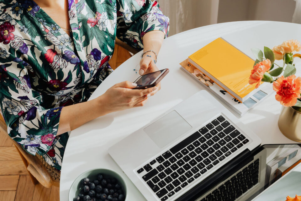 Woman working at a computer in floral top