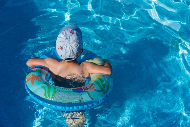 Young boy taking swimming lessons
