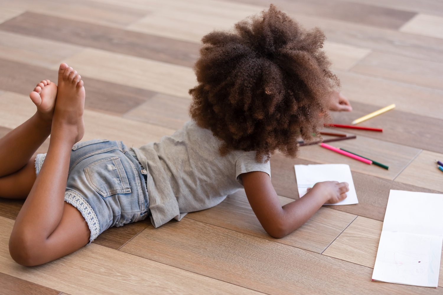 Girl coloring on the floor