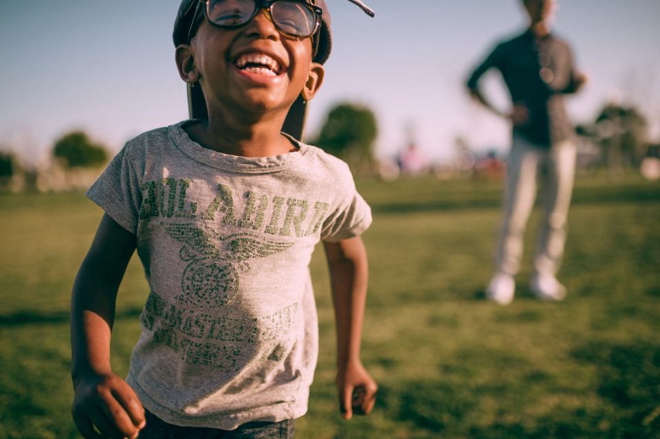 Young boy in glasses playing doing 30 easy summer ideas