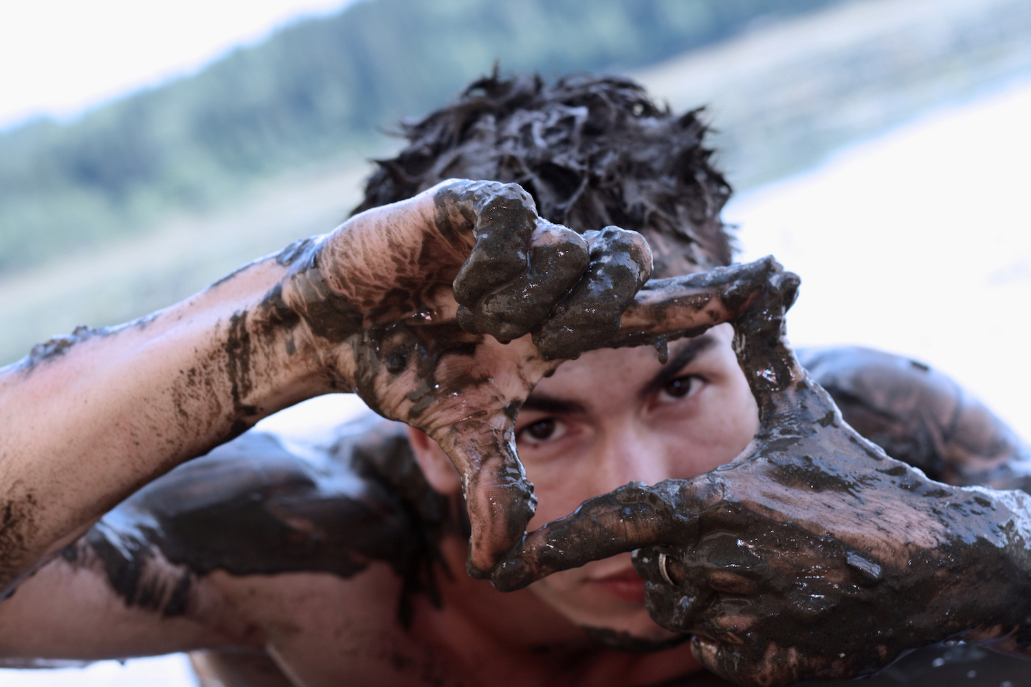 Teen boy in mud