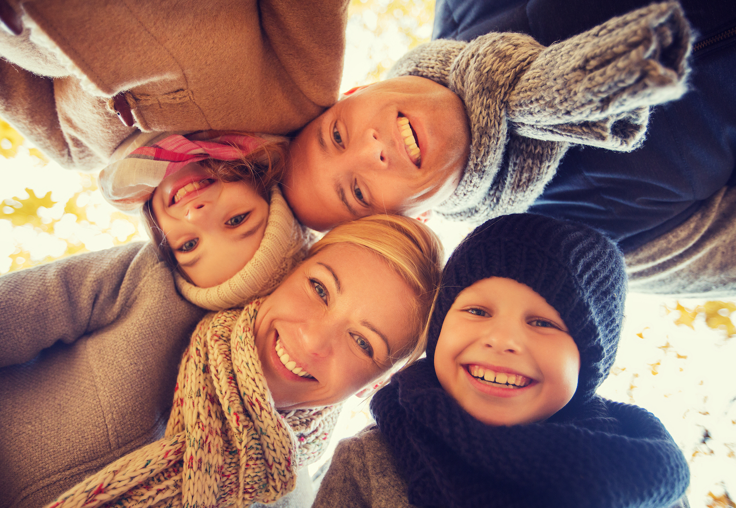 Family standing around in a circle in winter clothes