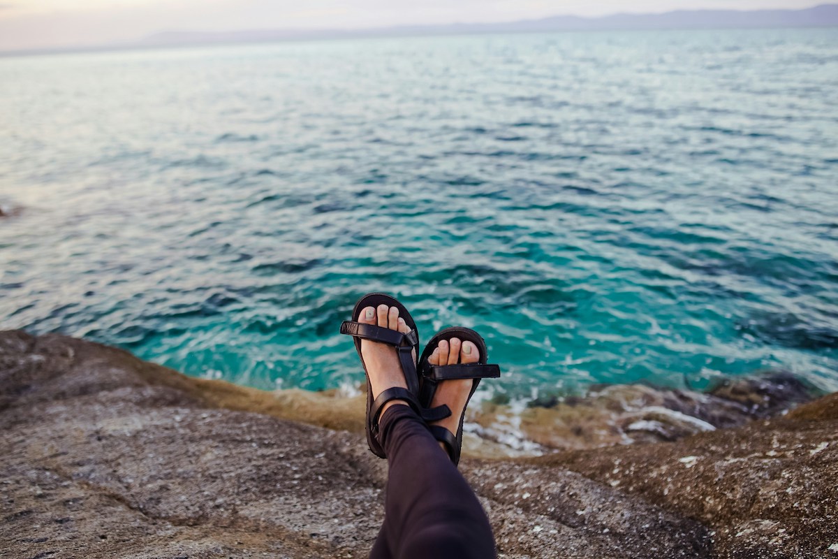 Womans sandals by the ocean