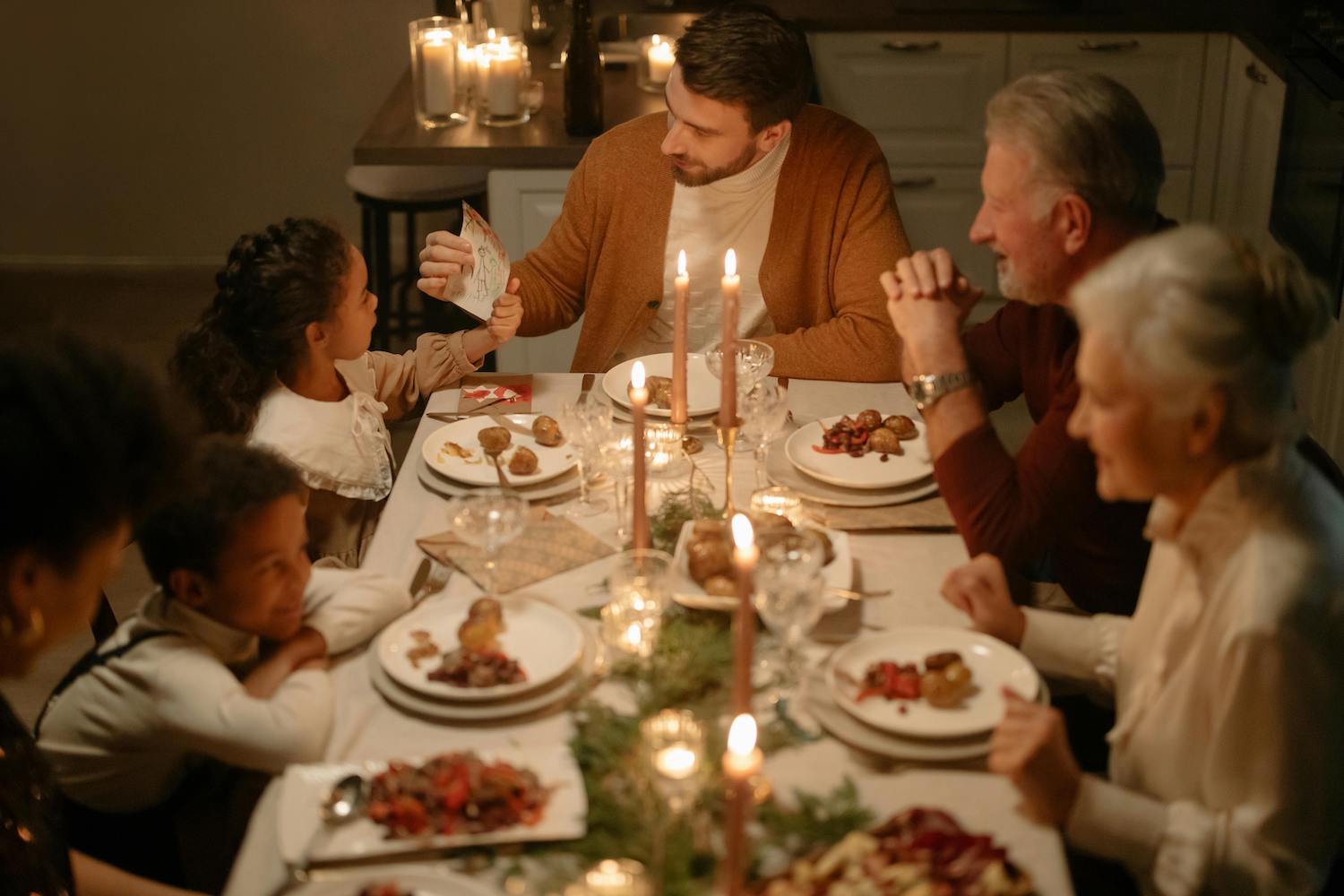 Family sitting around a holiday dinner table