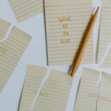 Words on torn paper about giving your worries to god