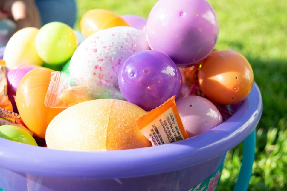 Easter basket full of colorful eggs and candy