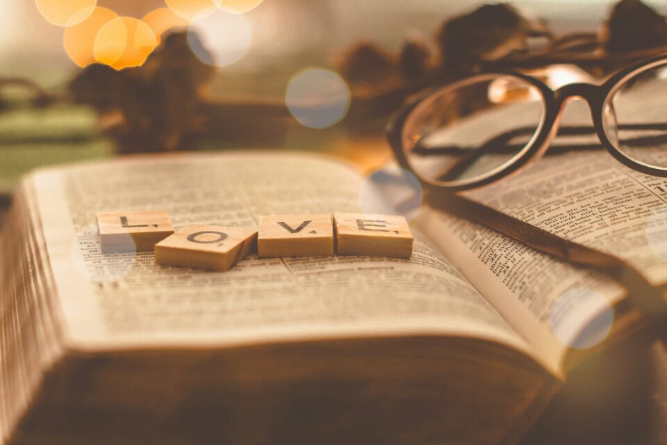 God as a father love on top of a bible with glasses