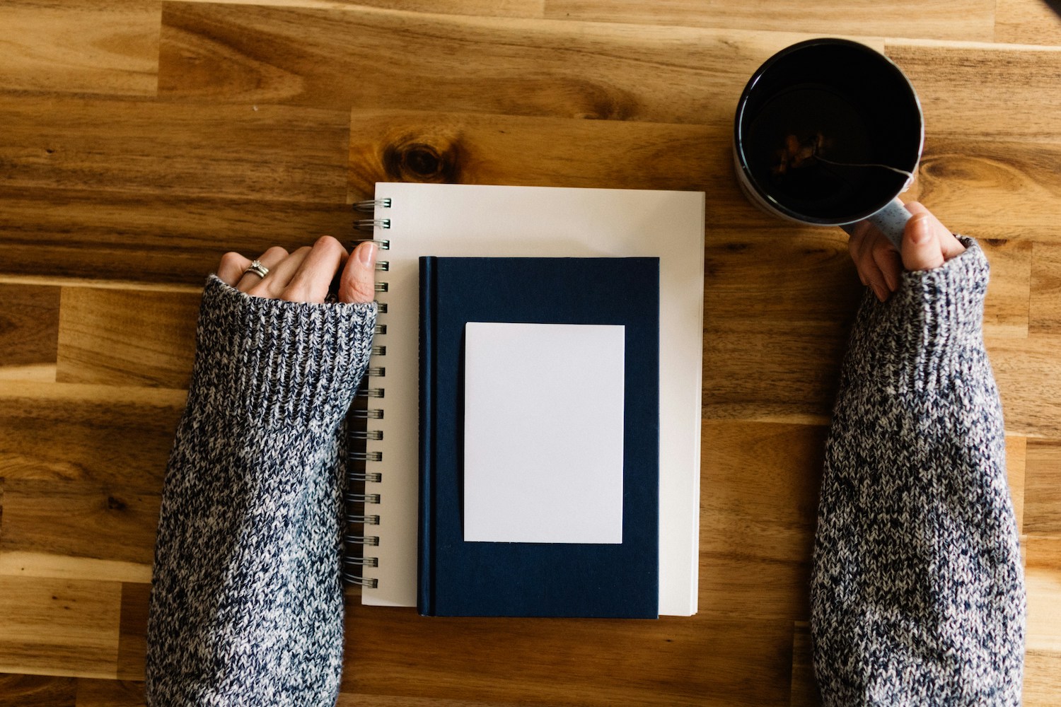 A planner plan - Woman sitting with a mile of notebooks