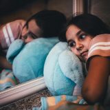 17 Bible verses to calm anxiety - Anxious girl laying on bed