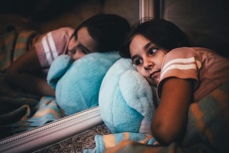 17 Bible verses to calm anxiety - Anxious girl laying on bed