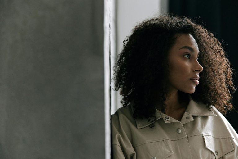 Bible quotes about confidence - Woman with curly hair looking out window