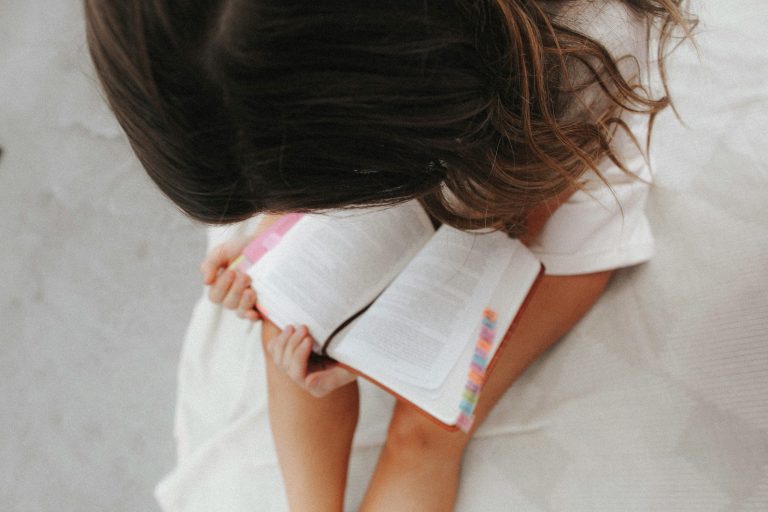 The Best Bible for Kids: girl reading bible on bed