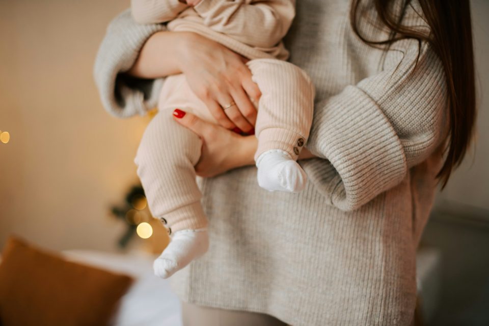 Mom holding baby while dealing with Postpartum Challenges