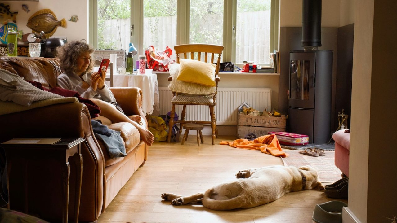 Woman sitting in house overwhelmed, learning to combat mom guilt