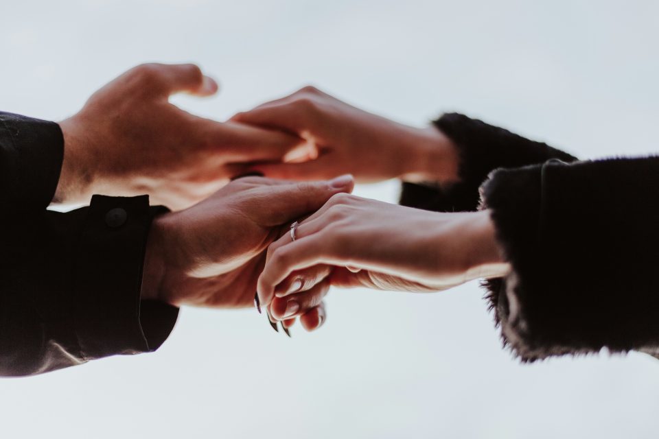Man and wife holding hands discussing keys to marriage connection