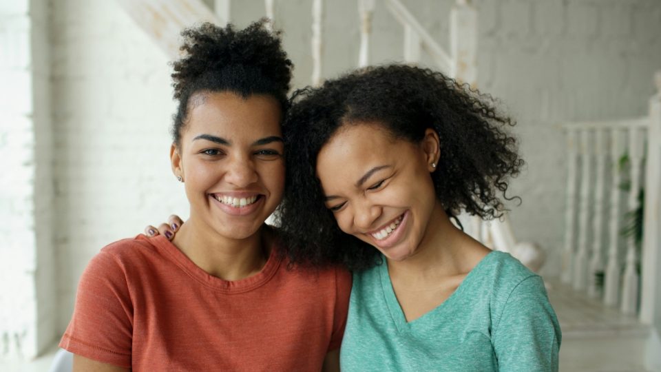 Mom and daughter smiling in living room - Learning to Parent Grown Children with Grace
